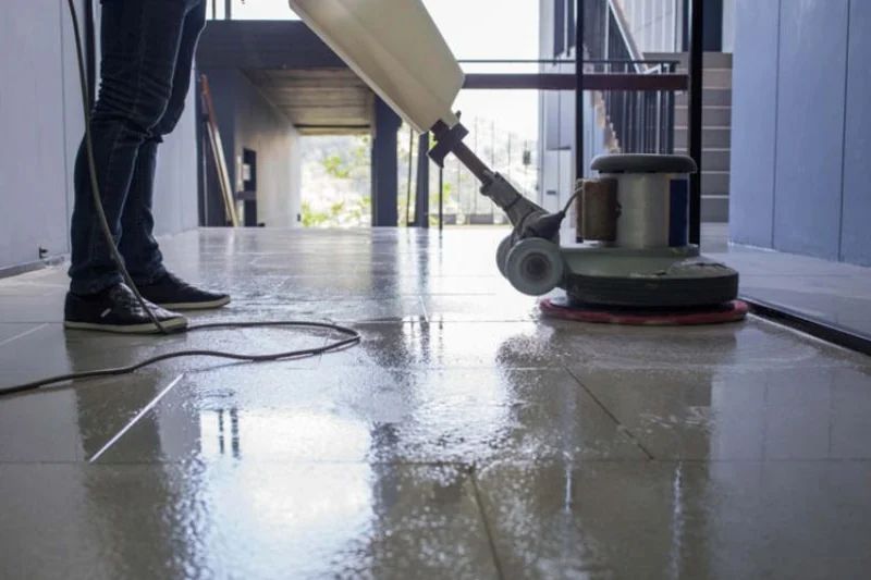 A floor scrubber polishing tiled flooring